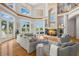 Grand living room boasts hardwood floors, large windows, a fireplace, and elegant furnishings for luxury living at 6785 Burning Tree Dr, Seminole, FL 33777