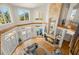 Bright and airy living room with a stone fireplace and access to outdoor living at 6785 Burning Tree Dr, Seminole, FL 33777