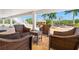 Comfortable outdoor seating arrangement featuring wicker chairs around a glass table, perfect for enjoying the outdoor space at 6785 Burning Tree Dr, Seminole, FL 33777