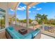 Expansive covered patio with outdoor seating and serene views of the pool and grounds at 6785 Burning Tree Dr, Seminole, FL 33777