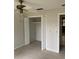 Bedroom features a ceiling fan, carpet floors, and a closet at 1750 Braxton Bragg Ln, Clearwater, FL 33765