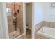 A bathroom with a glass-enclosed shower and soaking tub at 18311 Arbor Crest Dr, Hudson, FL 34667