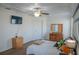 Bedroom with light walls, wood flooring, and a window with natural light at 18311 Arbor Crest Dr, Hudson, FL 34667