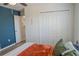 A bedroom featuring wood-look floors, blue accent wall, and closet at 18311 Arbor Crest Dr, Hudson, FL 34667