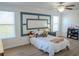 Bright bedroom with a cozy bed, a decorative wall panel, and a ceiling fan at 18311 Arbor Crest Dr, Hudson, FL 34667