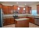 Kitchen featuring granite countertops, modern appliances, and wood cabinetry at 18311 Arbor Crest Dr, Hudson, FL 34667