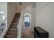 Staircase with wood steps and white railing leading to the home's upper level at 18311 Arbor Crest Dr, Hudson, FL 34667