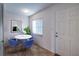 Cozy dining area featuring a round table with chairs, a window, and a door at 18325 Gulf Blvd # 405, Redington Shores, FL 33708