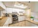 Well-equipped kitchen with stainless steel appliances, white cabinetry, and ample counter space at 18325 Gulf Blvd # 405, Redington Shores, FL 33708