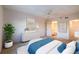 Comfortable main bedroom with a ceiling fan, decor, and an en-suite bathroom at 18325 Gulf Blvd # 405, Redington Shores, FL 33708