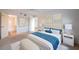 Spacious main bedroom with soft decor, light walls, ceiling fan, and an en-suite bathroom at 18325 Gulf Blvd # 405, Redington Shores, FL 33708