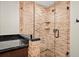 Bathroom features brick shower and brick accent wall, along with a dark countertop at 319 26Th W St, Bradenton, FL 34205