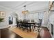 Dining room features a large table with seating for eight and hardwood floors with stylish light fixture at 319 26Th W St, Bradenton, FL 34205