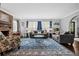 Charming living room with hardwood floors, area rug, a brick fireplace, and plenty of seating at 319 26Th W St, Bradenton, FL 34205