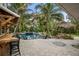 An inviting outdoor pool area boasts a tiki hut and bar, surrounded by tropical landscaping at 319 26Th W St, Bradenton, FL 34205