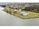 Scenic aerial view of community tennis courts adjacent to a peaceful lake and green spaces at 4732 Lake Blvd # A, Clearwater, FL 33762