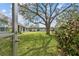 View of a well-maintained backyard with lush greenery, mature trees, and the building exterior at 4732 Lake Blvd # A, Clearwater, FL 33762