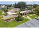 Aerial of the clubhouse with manicured landscaping, mature palms, and accessible parking at 4732 Lake Blvd # A, Clearwater, FL 33762