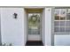 Close-up of the front door with a decorative wreath and textured wall at 4732 Lake Blvd # A, Clearwater, FL 33762