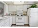 Functional kitchen with a white appliances and ample cabinet space at 4732 Lake Blvd # A, Clearwater, FL 33762