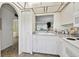 Shows a kitchen sink area, view to living room, and white cabinets at 4732 Lake Blvd # A, Clearwater, FL 33762