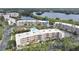 A beautiful condo community with a pool, lush landscaping, and a serene lake view at 6315 Shoreline Dr # 3208, St Petersburg, FL 33708
