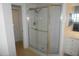 Walk-in shower with glass doors, tiled walls and floor, and shower head at 6315 Shoreline Dr # 3208, St Petersburg, FL 33708