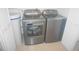 Modern laundry room featuring gray washer and dryer units and neutral tile floor at 6315 Shoreline Dr # 3208, St Petersburg, FL 33708