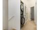 Convenient hallway laundry closet with stacked washer and dryer at 9111 Moonlit Meadows Loop, Riverview, FL 33578