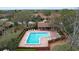 Aerial view of a sparkling community pool and clubhouse surrounded by lush landscaping and trees at 9888 Lake Seminole E Dr, Largo, FL 33773