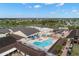 This aerial view highlights the community pool, recreational facilities, and golf cart parking at 1311 Caloosa Lake Ct, Sun City Center, FL 33573