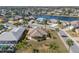 Beautiful aerial view of home with lush landscaping and a manicured lawn at 1311 Caloosa Lake Ct, Sun City Center, FL 33573