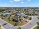 Aerial view of a home in a community with well-manicured lawns and landscaping at 1311 Caloosa Lake Ct, Sun City Center, FL 33573