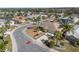 Aerial view of a home in a well-planned community, showcasing meticulous landscaping and street layout at 1311 Caloosa Lake Ct, Sun City Center, FL 33573
