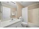Simple bathroom featuring a combination tub/shower, vanity, and seashell wallpaper for a beachy feel at 1311 Caloosa Lake Ct, Sun City Center, FL 33573