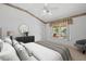 Relaxing primary bedroom with a view to the pool area, featuring neutral tones and a ceiling fan at 1311 Caloosa Lake Ct, Sun City Center, FL 33573