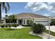 Charming single-story home featuring a well-manicured lawn, two car garage and welcoming screened in porch at 1311 Caloosa Lake Ct, Sun City Center, FL 33573