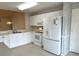 Bright kitchen with white appliances, tiled floors and ample countertop space for cooking and entertaining at 1311 Caloosa Lake Ct, Sun City Center, FL 33573