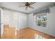 Bright and airy living room features hardwood floors, a ceiling fan, and natural light from the window at 1311 Caloosa Lake Ct, Sun City Center, FL 33573