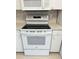 Close up of the white electric oven and range featuring updated features at 1311 Caloosa Lake Ct, Sun City Center, FL 33573