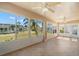 Bright sunroom with tiled floors and large windows offering expansive backyard views with exterior access at 1311 Caloosa Lake Ct, Sun City Center, FL 33573