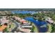 Beautiful aerial view showcases homes with colorful roofs surrounding a peaceful lake with a fountain at 15856 Cobble Mill Dr, Wimauma, FL 33598