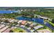 An aerial view of a neighborhood with waterfront properties, lush landscaping, and well-maintained streets at 15856 Cobble Mill Dr, Wimauma, FL 33598