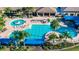 Aerial view of community pool with lounge chairs and palm trees at 15856 Cobble Mill Dr, Wimauma, FL 33598