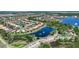 Expansive aerial view of homes nestled among lakes and lush greenery, highlighting community amenities at 15856 Cobble Mill Dr, Wimauma, FL 33598