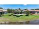 Scenic backyard with mature trees and screened-in porch overlooking a serene pond at 15856 Cobble Mill Dr, Wimauma, FL 33598