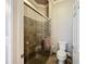 Elegant bathroom with glass-enclosed tile shower and modern toilet at 15856 Cobble Mill Dr, Wimauma, FL 33598