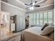 Comfortable bedroom featuring a decorative cabinet and plantation shutters at 15856 Cobble Mill Dr, Wimauma, FL 33598