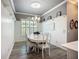 Elegant dining room featuring wainscoting, stylish chandelier, and ample seating for formal gatherings at 15856 Cobble Mill Dr, Wimauma, FL 33598