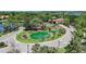 Aerial view of the gated community entrance with lush landscaping, serene water features, and guard house at 15856 Cobble Mill Dr, Wimauma, FL 33598